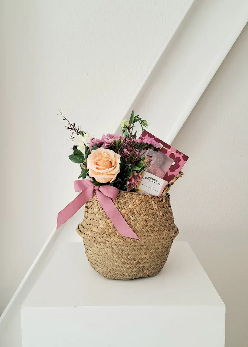 Mother's Day round basket with heart chocolate, blooms, and a notecard.