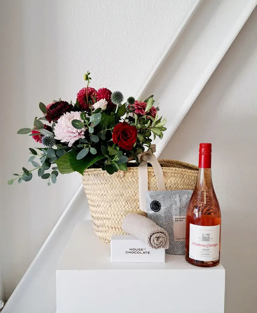 Valentine's Day Gift Basket with fresh blooms, rosé, and chocolate.