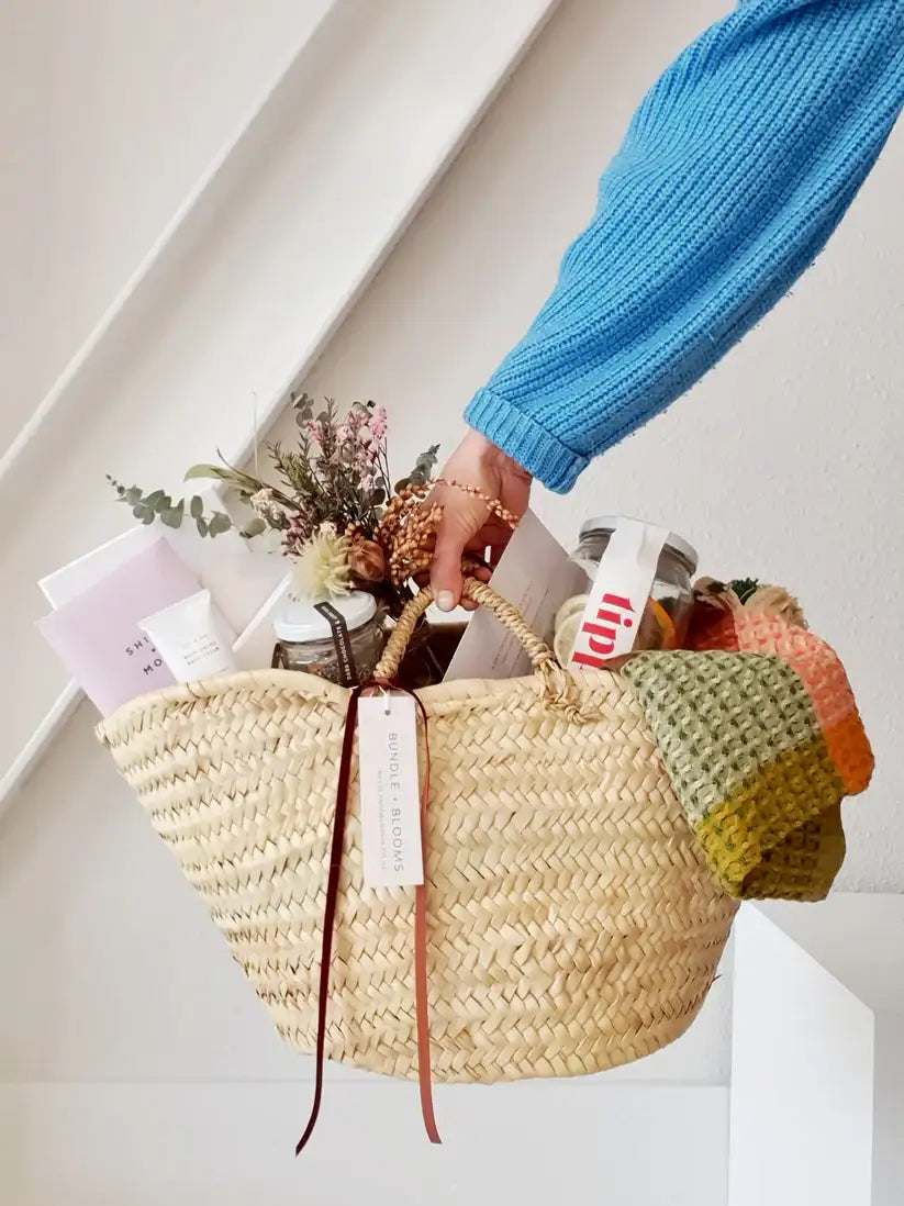 Gift Basket of Twenty25 featuring cocktail kit, chocolates, and beauty items.