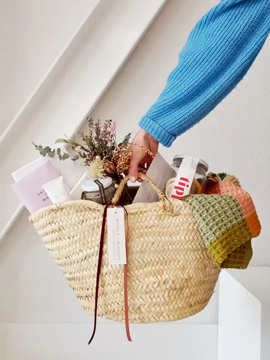 Gift Basket of Twenty25 featuring cocktail kit, chocolates, and beauty items.