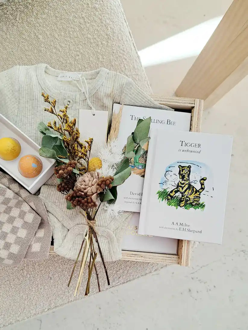 Luxury Welcome Home Baby Gift Box featuring organic baby clothes, dried flowers, and a heartfelt card.